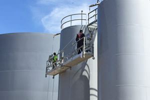 painters spray painting steel storage tanks, Farmington Hills, MI