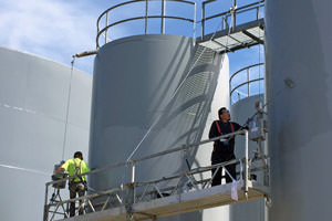 workers spray painting exterior tanks in Massillon, Ohio