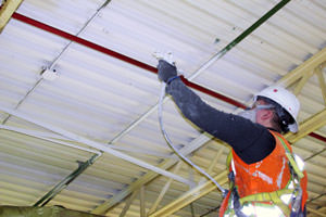 spray painting a metal ceiling in Flint, Michigan