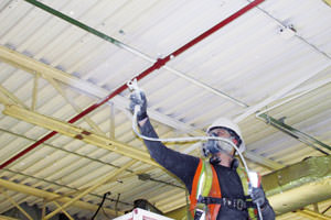 painting underway of metal ceiling by a Lansing MI painting contractor