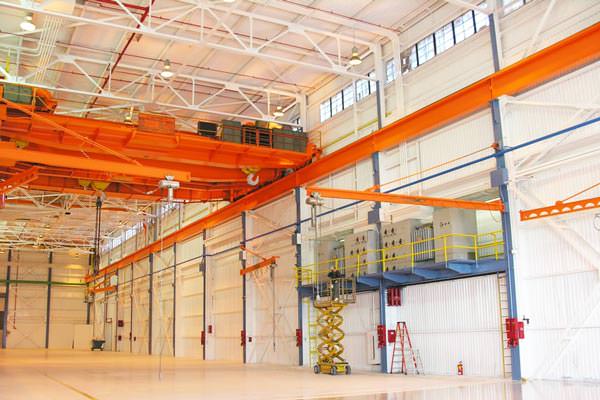 industrial painting of walls and steel beams in a factory