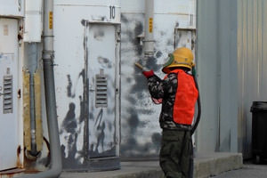 worker sand blasting in Erie, Pennsylvania